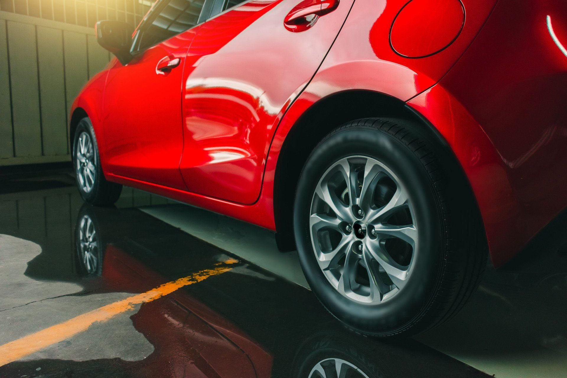 The body and rear wheel of a red vehicle